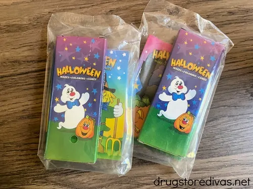 Two small packages with a Halloween coloring book and pack of crayons in each.