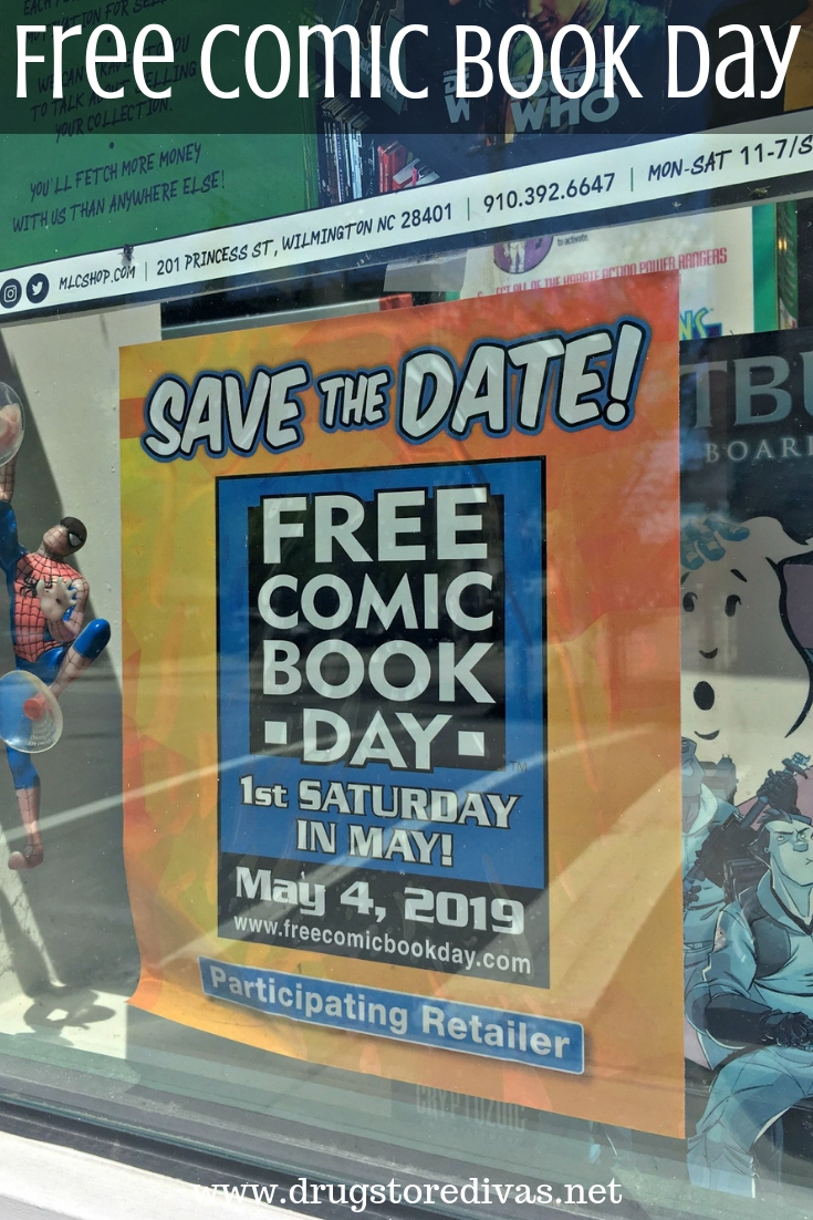 A poster about free comic book day in a store window with the words "Free Comic Book Day" digitally written on top.
