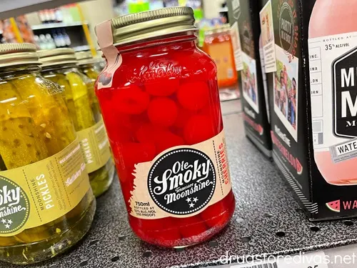 A bottle off Old Smoky Moonshine cherries on a shelf.