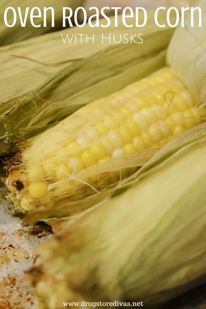 Three pieces of corn in the husk on a sheet pan, with one of the husks pulled pack, and the words "Oven-Roasted Corn With Husks" digitally written above it.