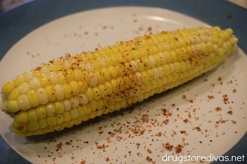 Corn on the cob covered in Tajín seasoning.