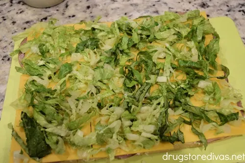 Lettuce slices and cheese spread on bread.