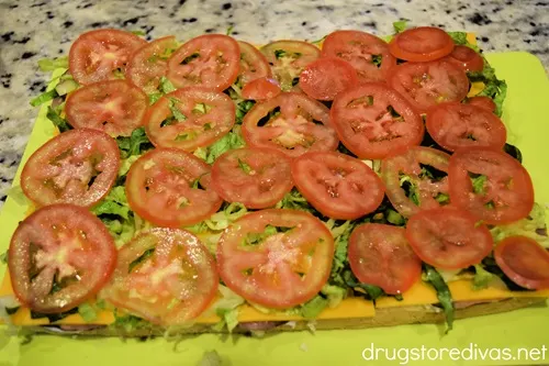 Tomato and lettuce slices and cheese spread on bread.