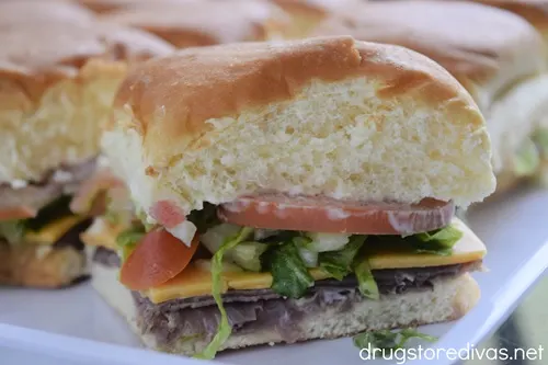 Roast beef sandwiches on a white tray.