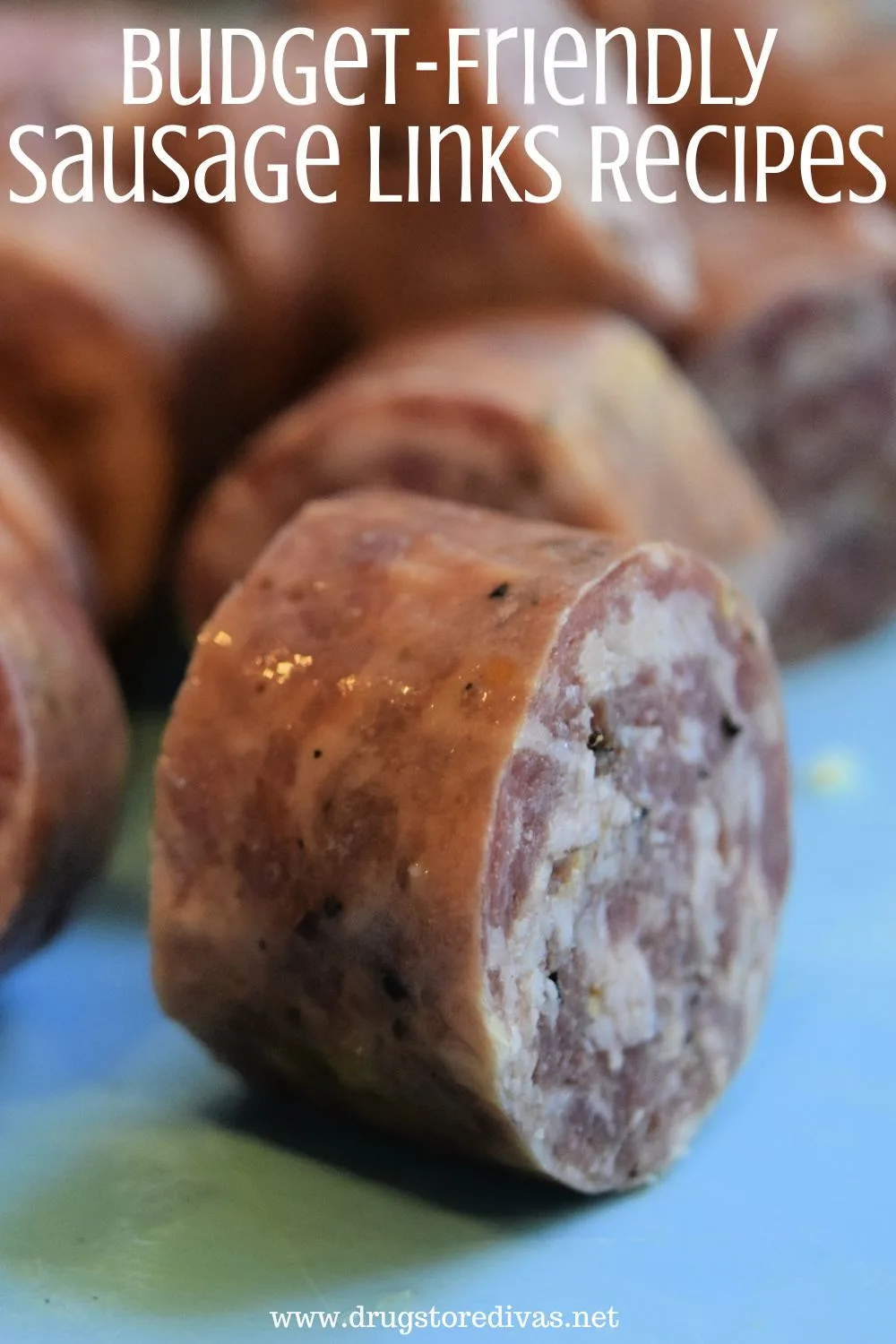 Bite-sized pieces of sausage links on a blue cutting board with the words 