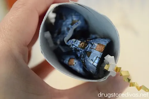 Blue Hershey's Kisses in a cardboard tube.