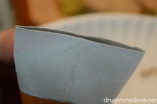 A cardboard tube folded in half.