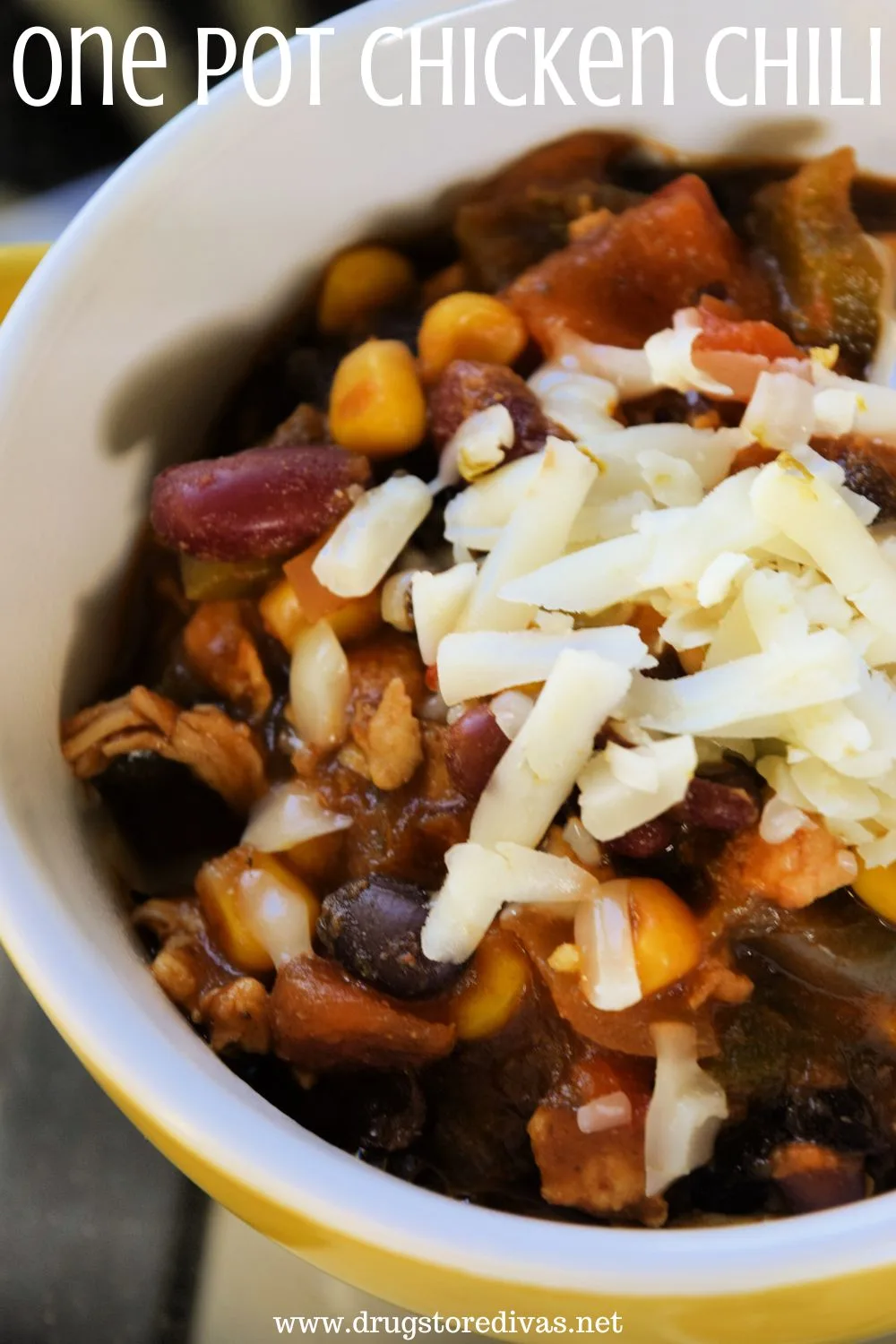 A bowl of chili with cheese on top and the words 