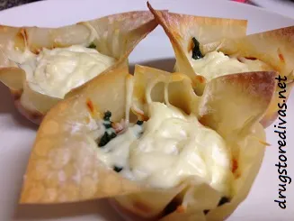 Three lasagna cups on a plate.