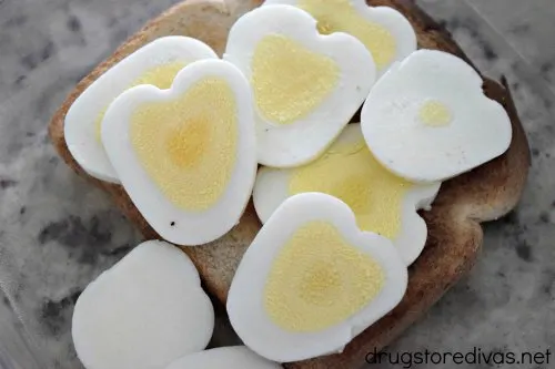 Heart shaped egg sliced on top of toast.