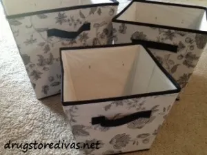 Three black and white storage bins.