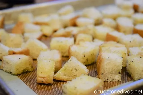 Bread cubes on a baking sheet.