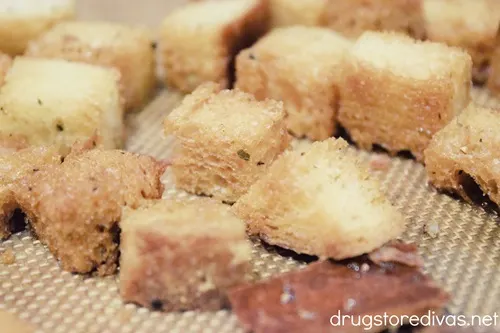 Homemade croutons on a baking mat.
