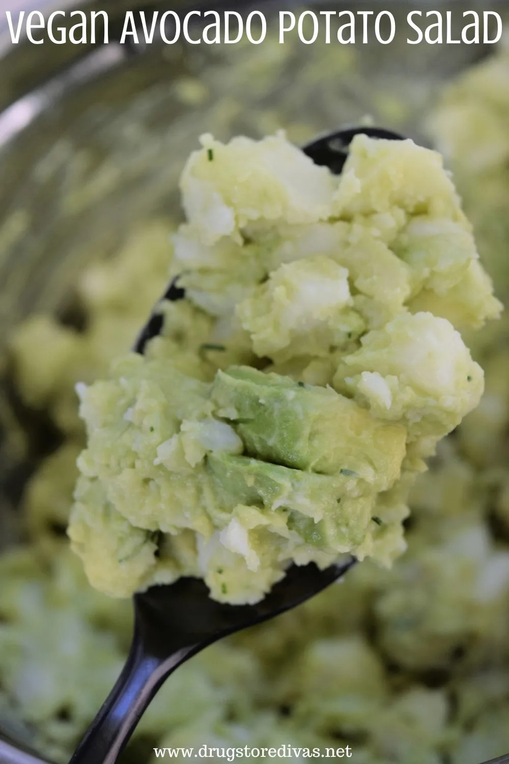 A spoon holding a scoop of avocado potato salad with the words 