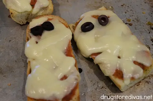 Coked French bread pizzas that look like a mummy on a cookie sheet.