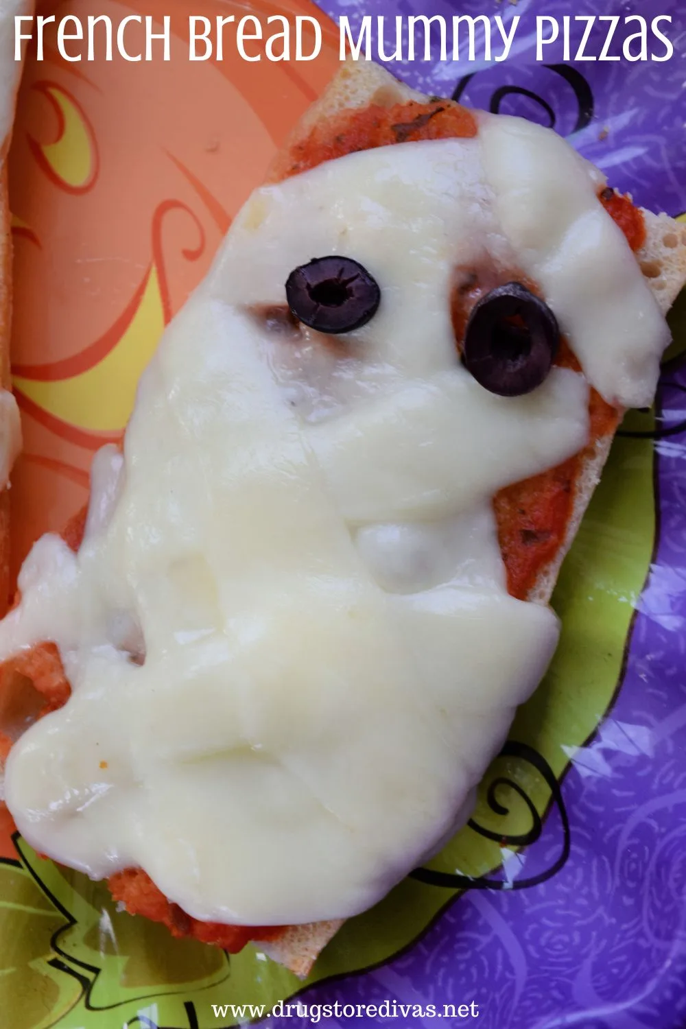 Pizza that's made to look like a mummy on a Halloween tray with the words 