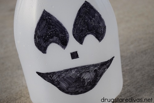 Ghost face drawn on a milk jug.