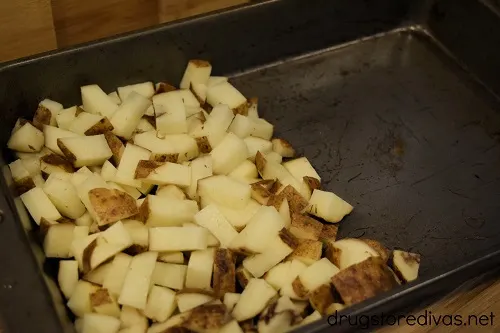 Diced potatoes on one side of a pan.