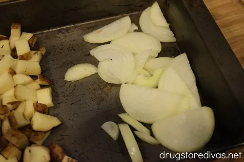 Sliced onions on one side of a pan.