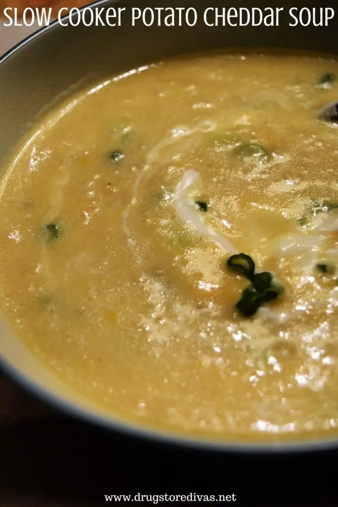 A bowl of potato soup with the words "Slow Cooker Potato Cheddar Soup" digitally written on top.