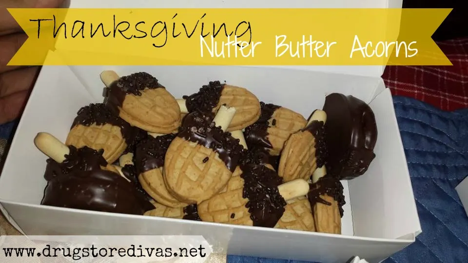 Nutter Butter Cookies decorated to look like acorns, in a box, with the words "Thanksgiving Nutter Butter Acorns" digitally written on top.