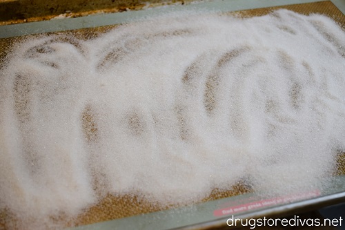 Sugar spread across a silicone baking-mat lined cookie sheet.