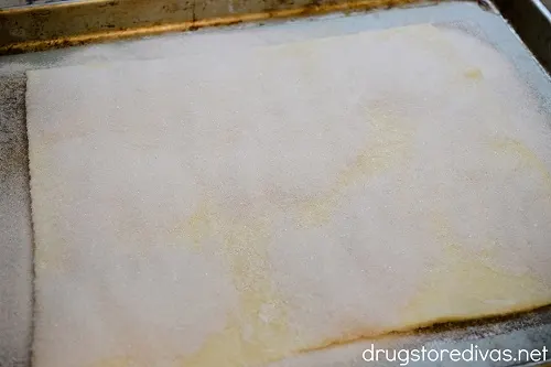 Sugar on top of a piece of puff pastry.