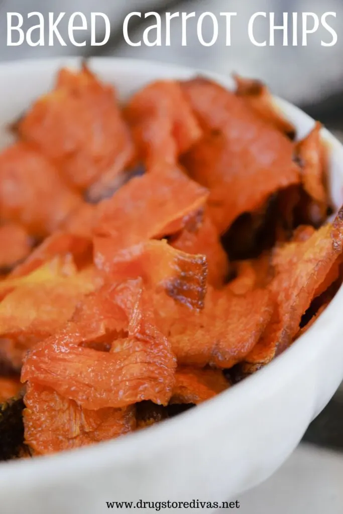 Carrot slices in a white bowl with the words "Baked Carrot Chips" digitally written on top.