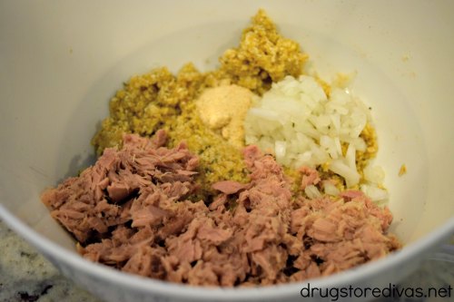 Tuna, onion, and a breadcrumb mixture in a bowl.