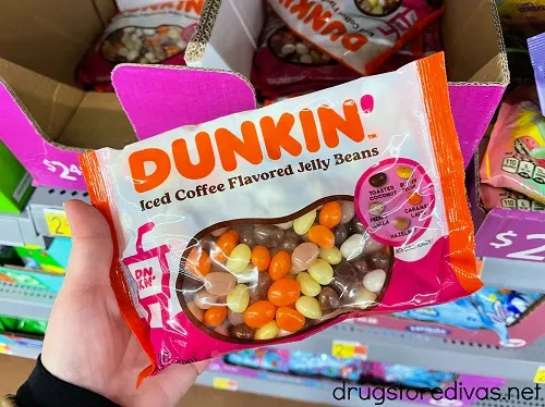A hand holding a bag of Dunkin' jelly beans.