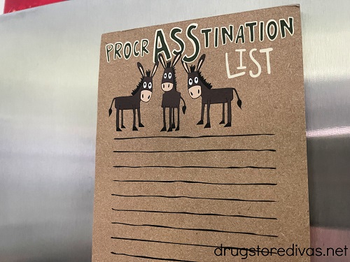 A note pad on a fridge that says, "Procrasstination list".