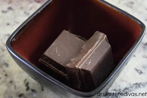 Two pieces of chocolate almond bark in a bowl.