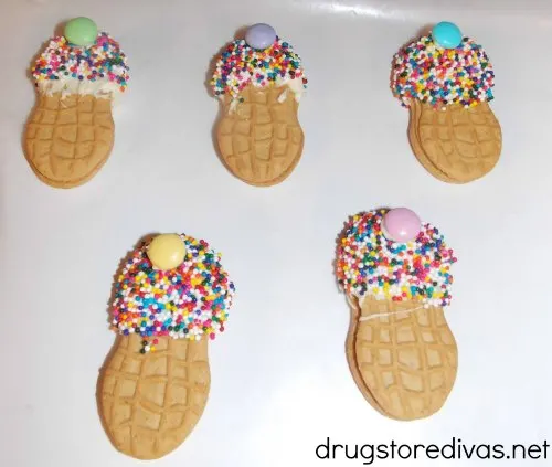 Cookies decorated to look like ice cream cones with the words "Nutter Butter Ice Cream Cone Cookies" digitally written on top.