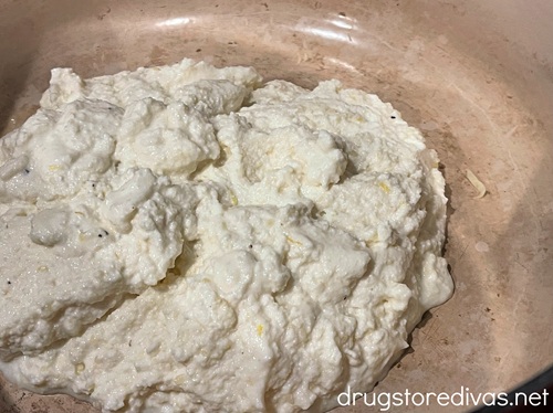 A ricotta cheese mixture at the bottom of a Dutch oven.