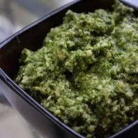 Pesto in a bowl with the words 