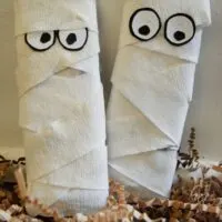 Two candy bars dressed up to look like mummies.