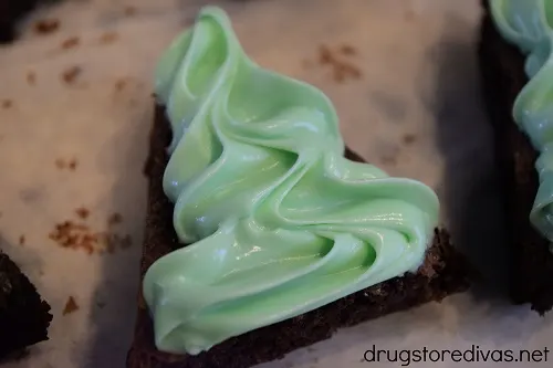 Green icing on a brownie triangle.