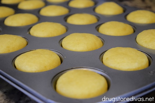 Baked mini lemon muffins in a pan.