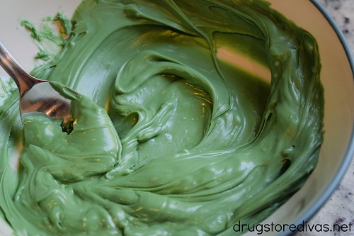 Melted green chocolate in a bowl.