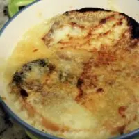 A bowl of French onion soup with the words 