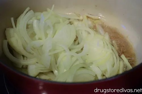 Sliced onions in a Dutch oven.