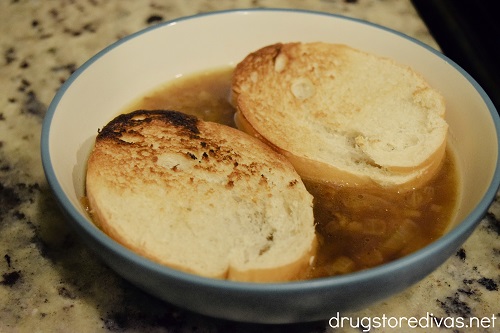 Two slices of bread and French Onion Soup in a bowl.