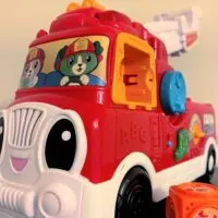 A toy firetruck with the words 