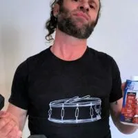 Man holding a weight and protein shake with the words 