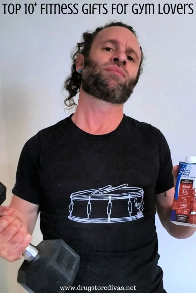 Man holding a weight and protein shake with the words "Top 10+ Fitness Gifts For Gym Lovers" digitally written on top.