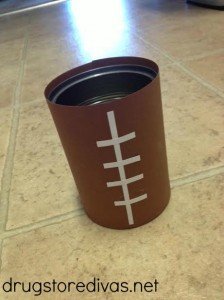 Are you ready for some FOOTBALL?! Get ready for your perfect football party with this homemade football flatware holder -- made from a soup can! It's perfect for your Super Bowl party or your next tailgate.