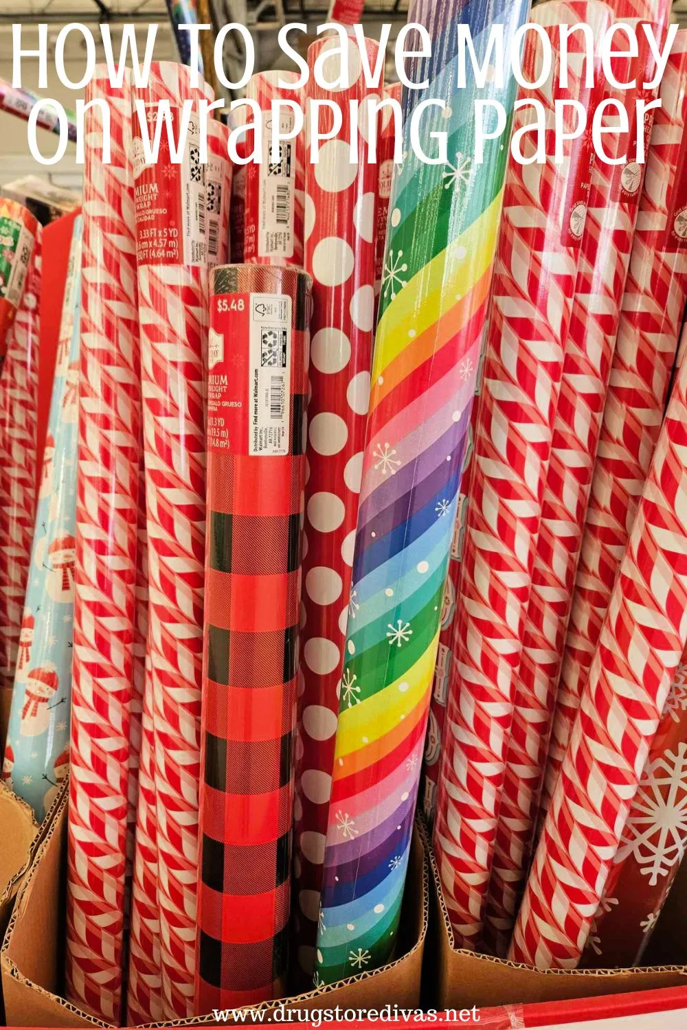 A bunch of rolls of wrapping paper in a box at the store with the words 