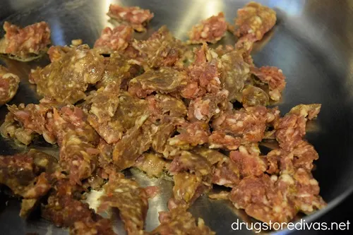 Sausage cooking in a pan.