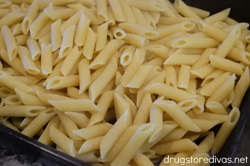 Penne pasta in a baking pan.