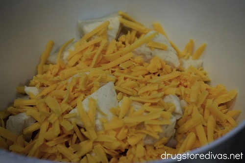 Cheddar cheese and biscuit pieces in a bowl.